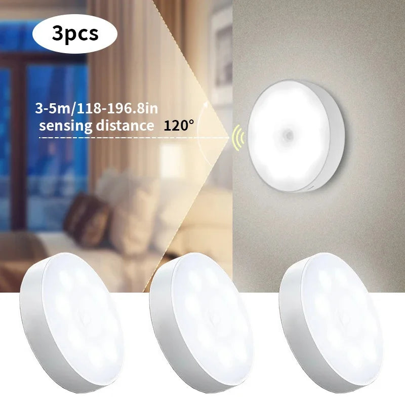 Set of three white round LED motion sensor night lights for indoor use